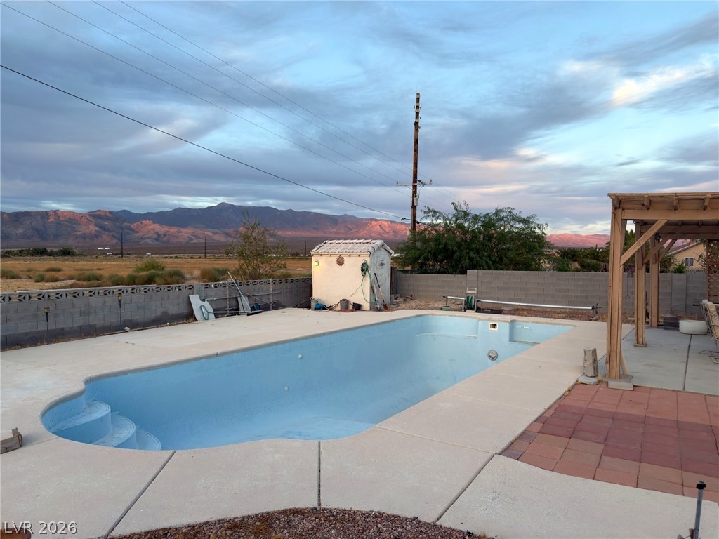 5470 Grain Mill Road Pahrump, NV 89061 - Photo 55 of 80 Panoramic mountain backdrops frame a private backyard pool and spacious concrete decking.