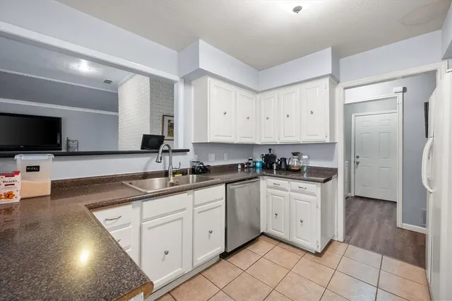 a kitchen with stainless steel appliances granite countertop a sink and a stove