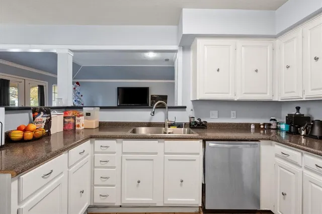 a kitchen with white cabinets and a sink