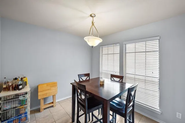a view of a dining room with furniture and window