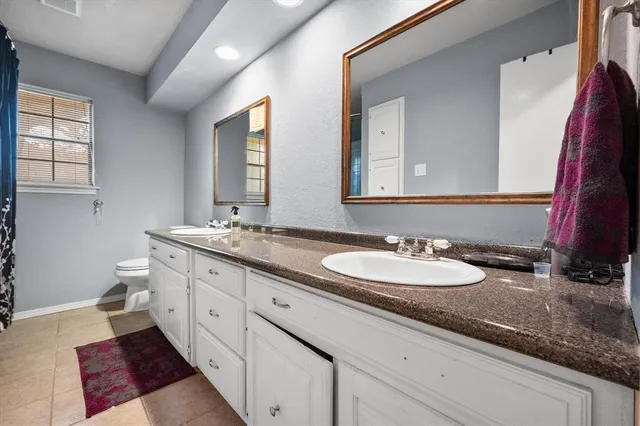 a bathroom with a double vanity sink and a mirror
