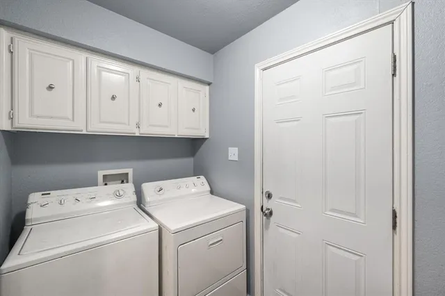 a view of storage and utility room with washer and dryer