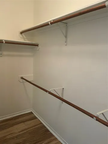 a white toilet sitting next to a white cabinet