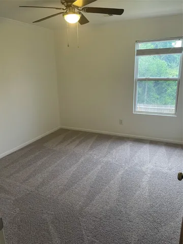 an empty room with a fan