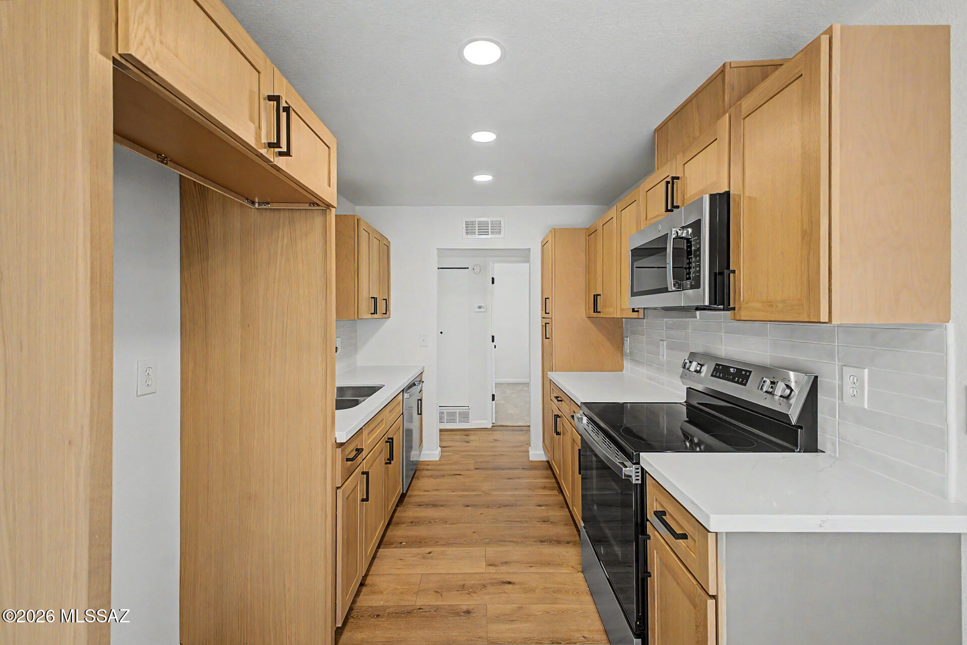 3402 South Kolb Road Tucson, AZ 85730 - Photo 3 of 32 a kitchen with stainless steel appliances granite countertop a stove a sink and a refrigerator