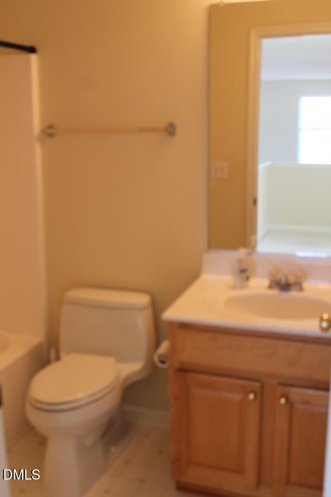 4717 Delta Lake Drive Raleigh, NC 27612 - Photo 18 of 20 a bathroom with a sink a toilet and vanity