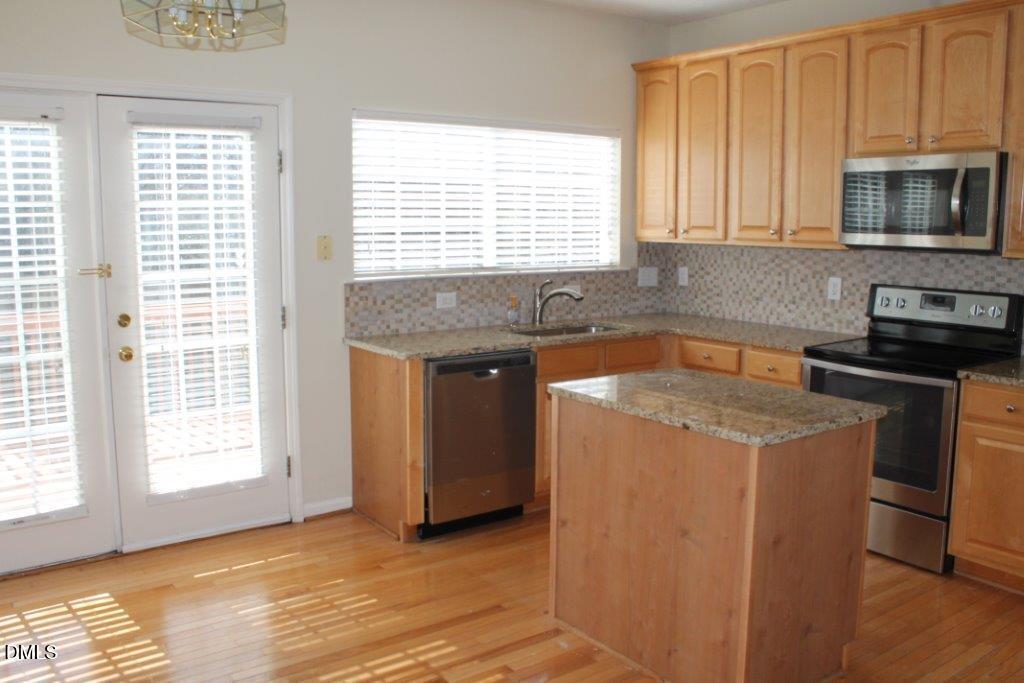 4717 Delta Lake Drive Raleigh, NC 27612 - Photo 7 of 20 a kitchen that has a sink and a stove in it