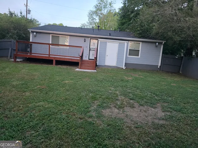 a view of a house with a backyard and a garden