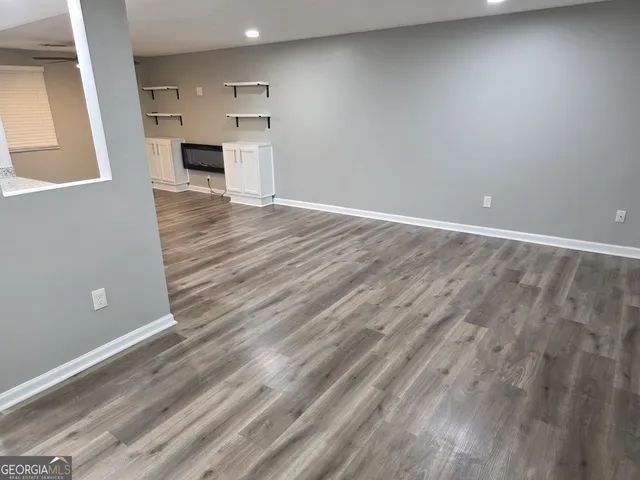a view of kitchen with microwave and cabinets