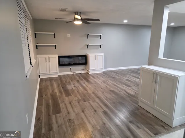 a view of a kitchen with wooden floor and a sink