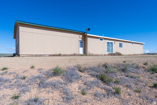 700 East Peter Springs Road Monticello, UT 84535 - Photo 5 of 57 Single-story structure featuring a tan exterior, dark roofline, and white trim