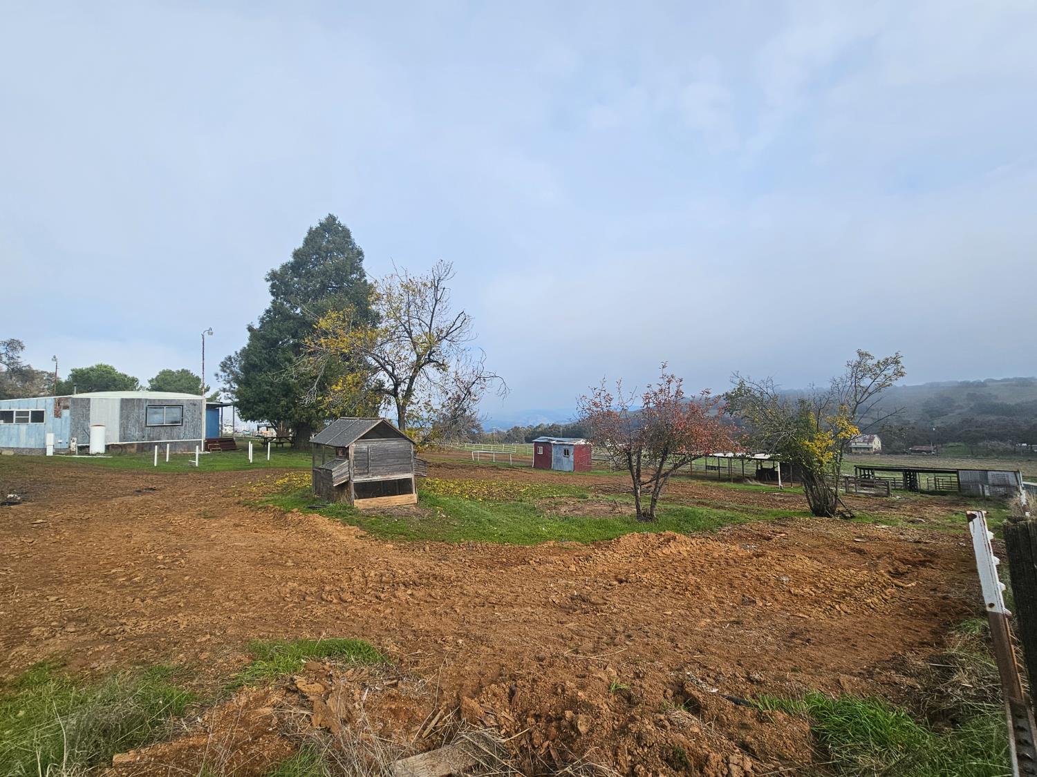 6746 Messinger Flat Road Valley Springs, CA 95252 - Photo 11 of 16 a view of a big house with a big yard and a large trees