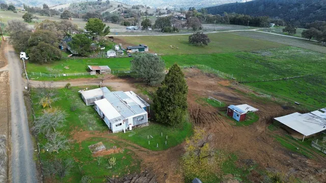 an aerial view of a house with outdoor space
