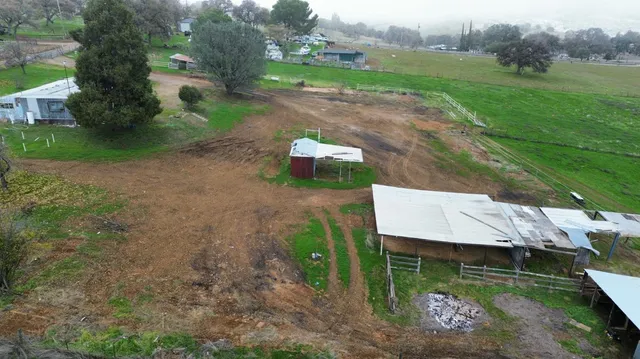 an aerial view of a house with a yard basket ball court and outdoor seating