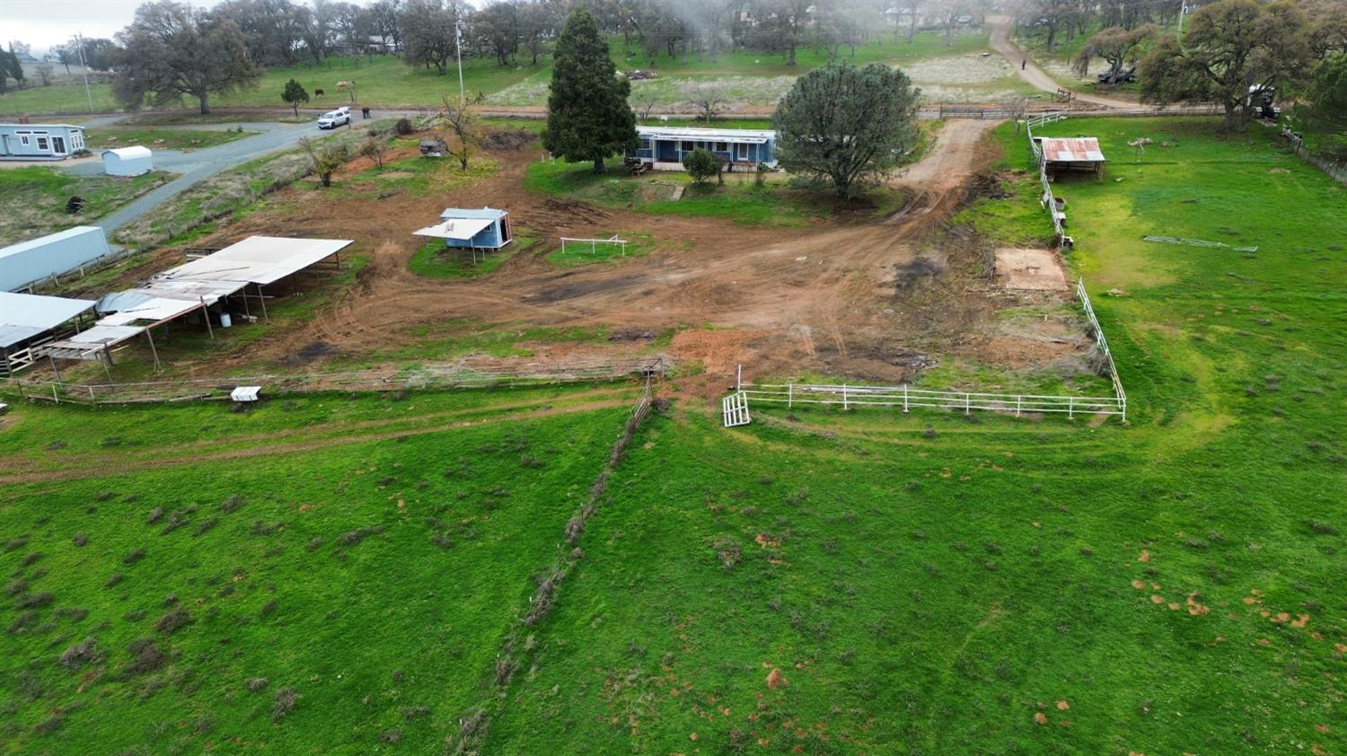 6746 Messinger Flat Road Valley Springs, CA 95252 - Photo 7 of 16 an aerial view of residential houses with outdoor space and trees