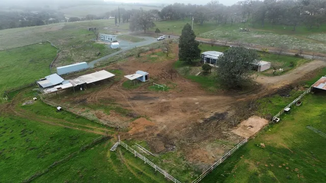 an aerial view of a house with a yard