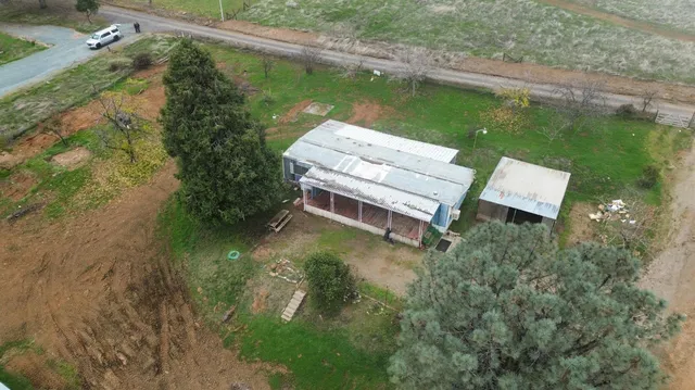 an aerial view of a house with a yard