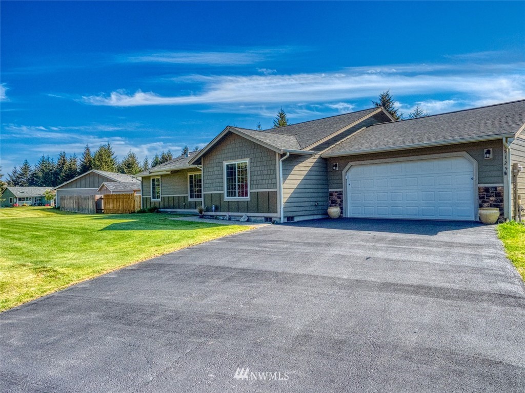 a view of a house with a yard and garage