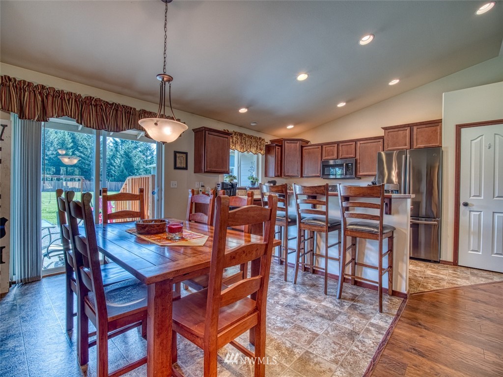 5125 180th Trail Southwest Rochester, WA 98579 - Photo 11 of 25 a view of a dining room with furniture window and wooden floor