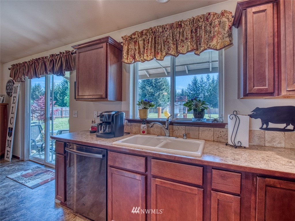 5125 180th Trail Southwest Rochester, WA 98579 - Photo 13 of 25 a kitchen with a sink a window and cabinets