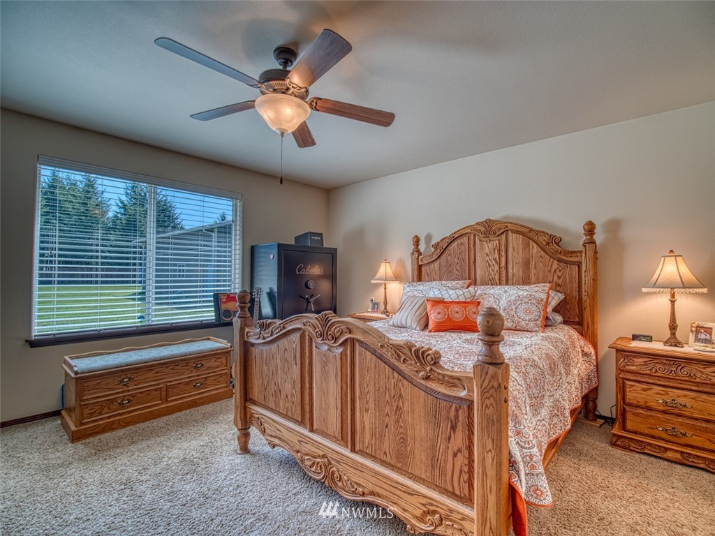 5125 180th Trail Southwest Rochester, WA 98579 - Photo 19 of 25 a bedroom with bed and a chandelier