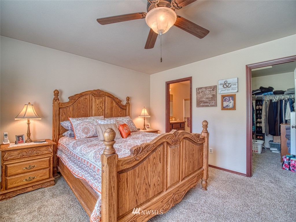5125 180th Trail Southwest Rochester, WA 98579 - Photo 20 of 25 a bedroom with bed and a chandelier