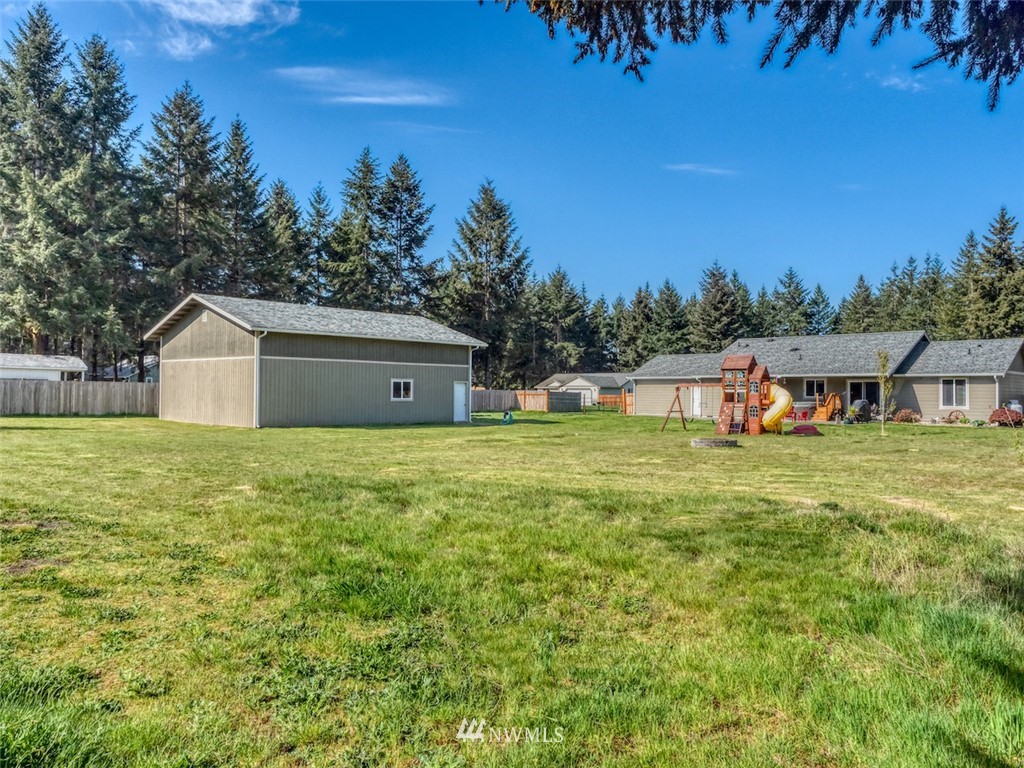 5125 180th Trail Southwest Rochester, WA 98579 - Photo 4 of 25 a front view of house with yard and trees in the background