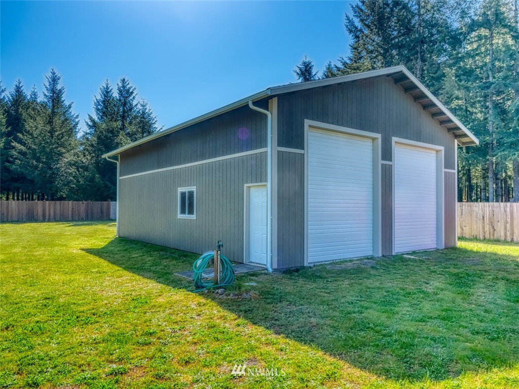 5125 180th Trail Southwest Rochester, WA 98579 - Photo 5 of 25 a view of backyard with potted plants and wooden fence