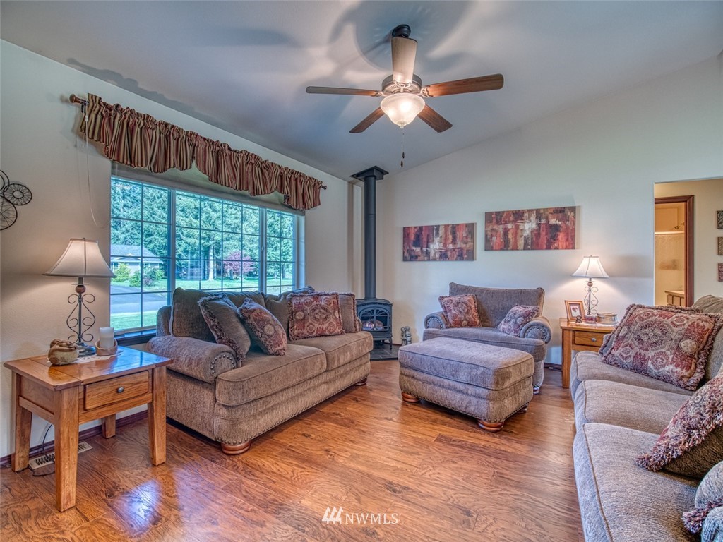 5125 180th Trail Southwest Rochester, WA 98579 - Photo 9 of 25 a living room with furniture ceiling fan and a window