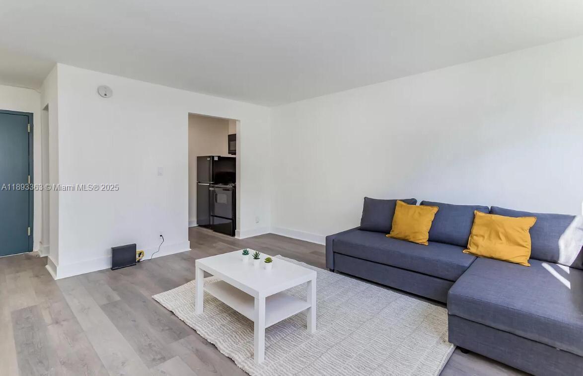 a living room with furniture and painting on the wall