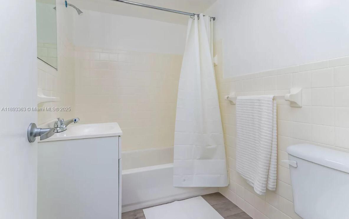 143 Southwest 9th Street, Unit 404 Miami, FL 33130 - Photo 9 of 14 a bathroom with a sink a toilet and shower