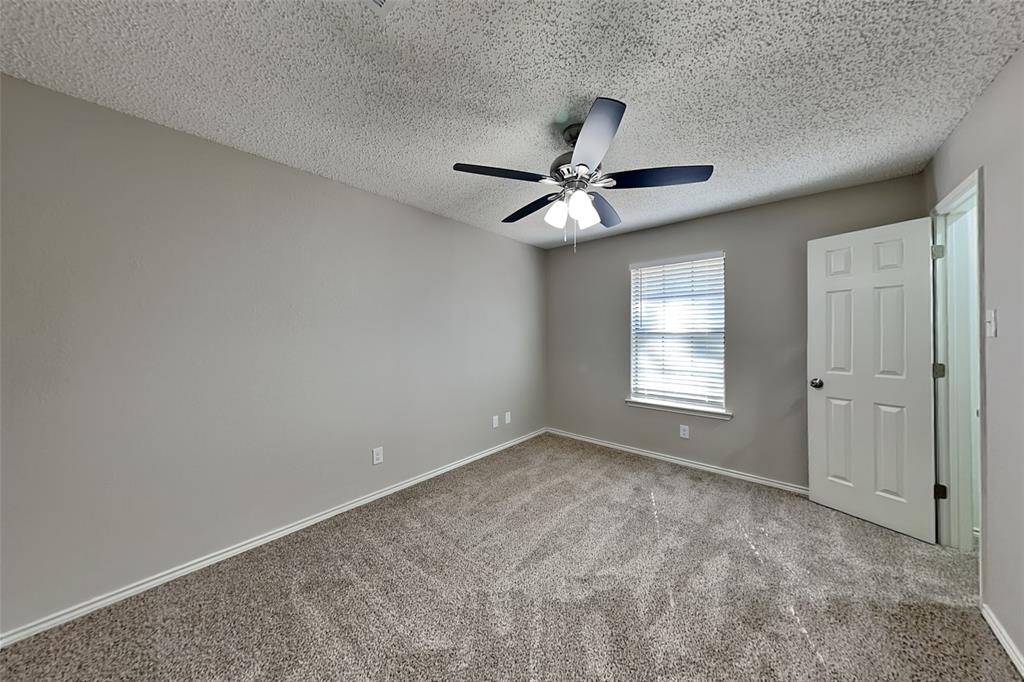 3920 Winston Drive Denton, TX 76210 - Photo 12 of 20 Carpeted empty room featuring a textured ceiling and ceiling fan