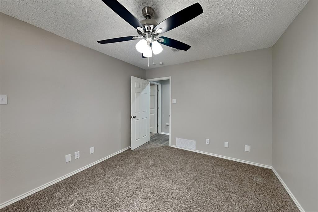 3920 Winston Drive Denton, TX 76210 - Photo 13 of 20 Unfurnished room featuring carpet floors, a textured ceiling, and a ceiling fan