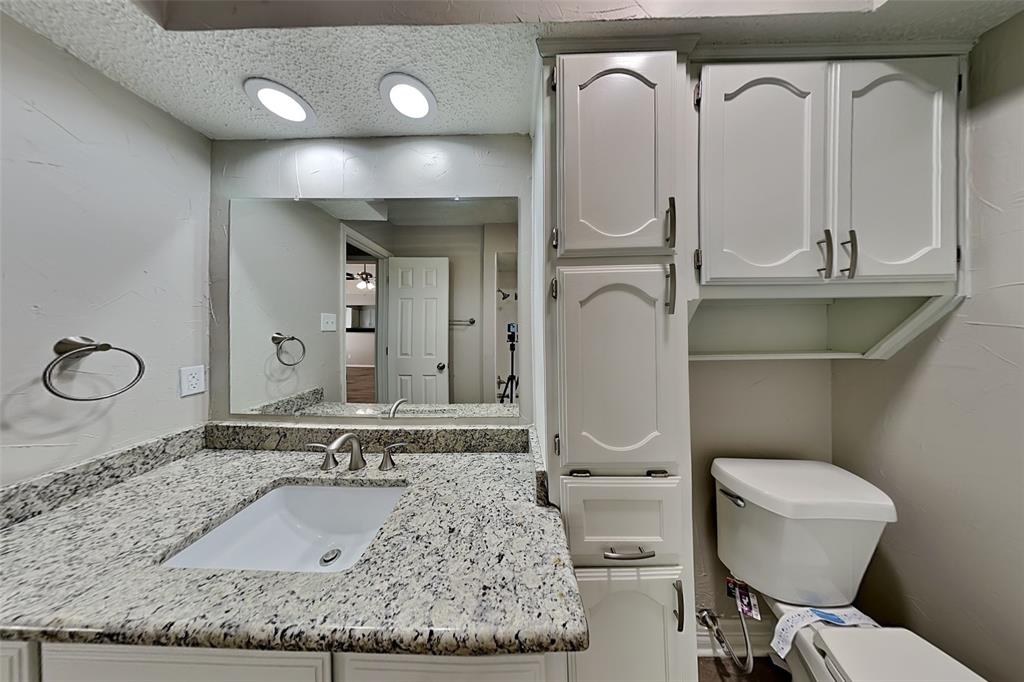 3920 Winston Drive Denton, TX 76210 - Photo 17 of 20 Half bath with vanity and a textured ceiling