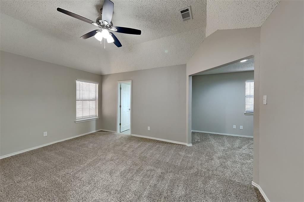 3920 Winston Drive Denton, TX 76210 - Photo 9 of 20 Unfurnished bedroom with a textured ceiling, vaulted ceiling, carpet floors, and a ceiling fan