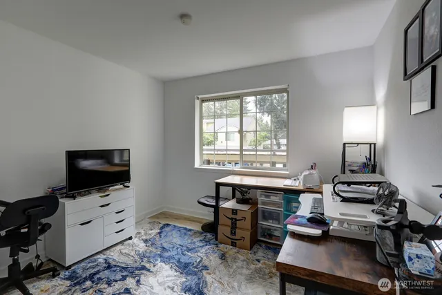 a view of a workspace with furniture and a window