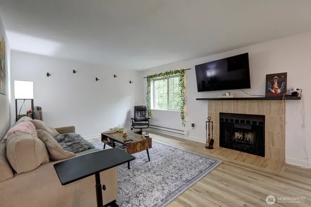 a living room with furniture a flat screen tv and a fireplace