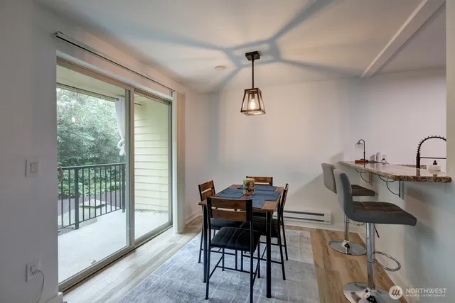 a view of a dining room with furniture window and wooden floor