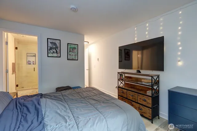 a bedroom with a bed and flat screen tv