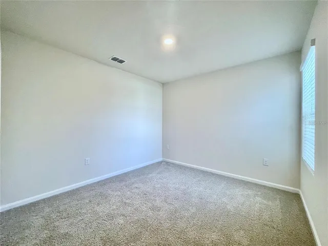 a view of wooden floor and windows in a room