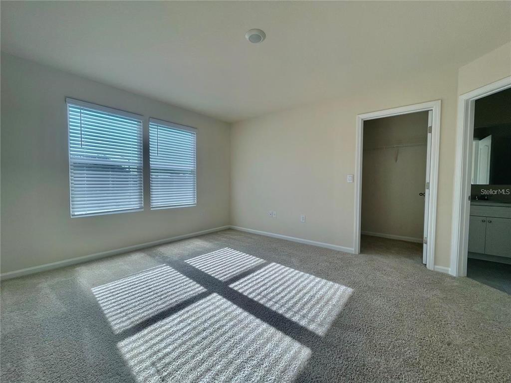 199 Redbud Road Palm Coast, FL 32137 - Photo 13 of 23 a view of wooden floor and windows in a room