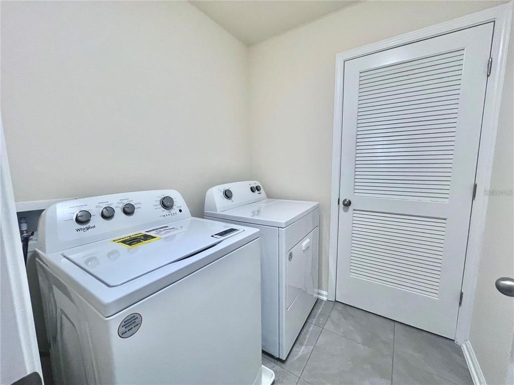 199 Redbud Road Palm Coast, FL 32137 - Photo 17 of 23 a utility room with dryer and washer