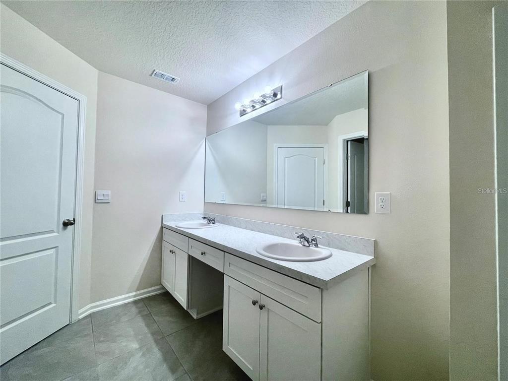 199 Redbud Road Palm Coast, FL 32137 - Photo 19 of 23 a bathroom with a granite countertop sink and a mirror