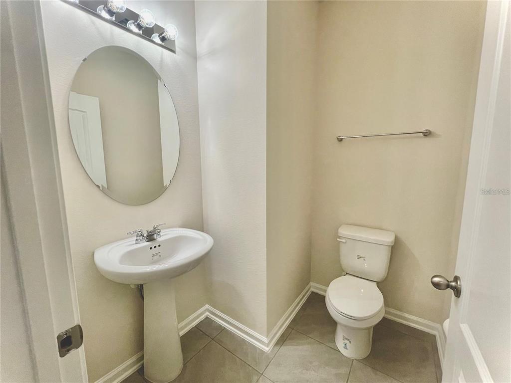 199 Redbud Road Palm Coast, FL 32137 - Photo 7 of 23 a bathroom with a toilet sink and mirror