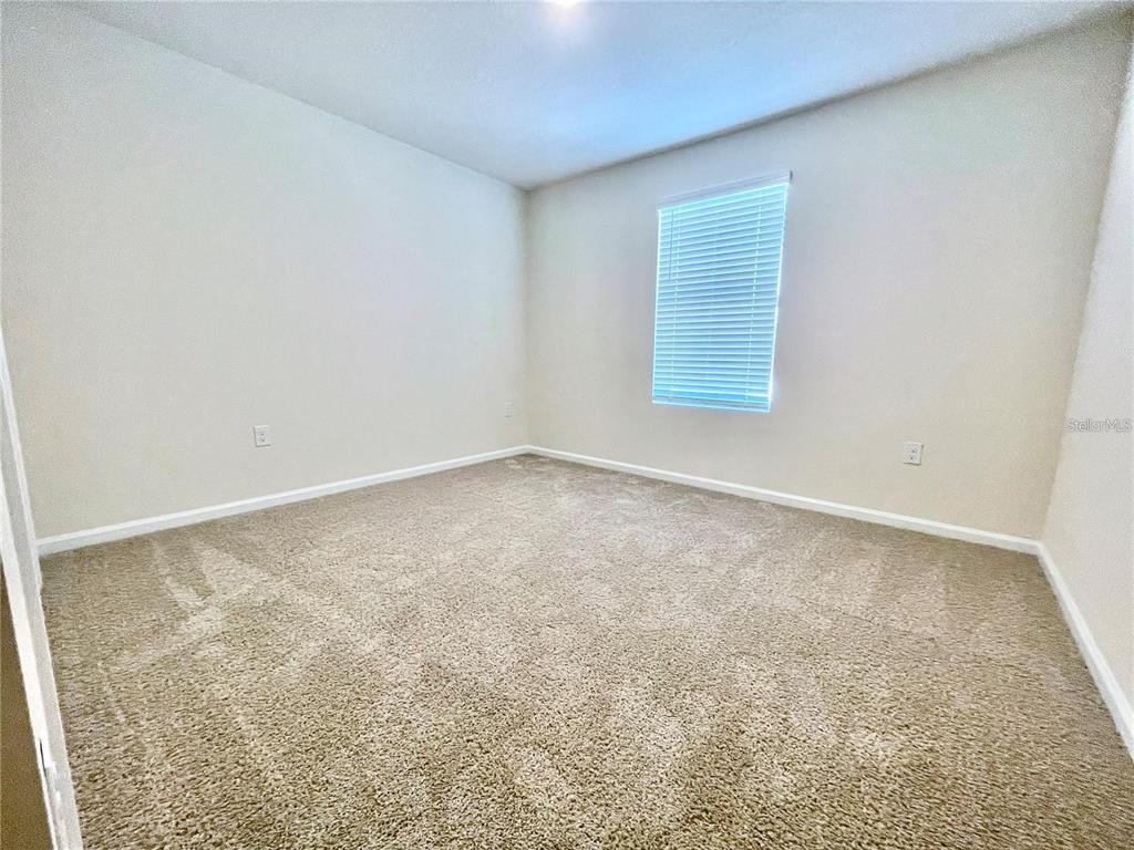199 Redbud Road Palm Coast, FL 32137 - Photo 8 of 23 an empty room with a window
