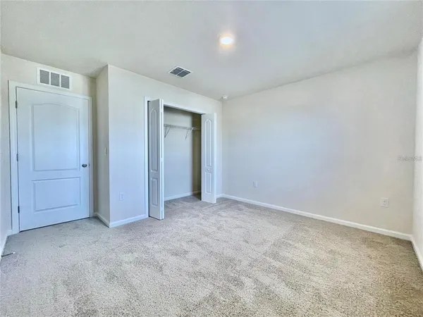 a view of an empty room and entryway
