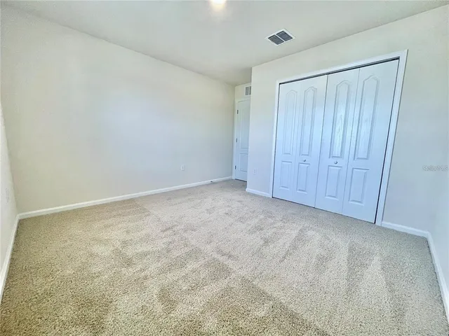 a bathroom with a sink a toilet and a large mirror