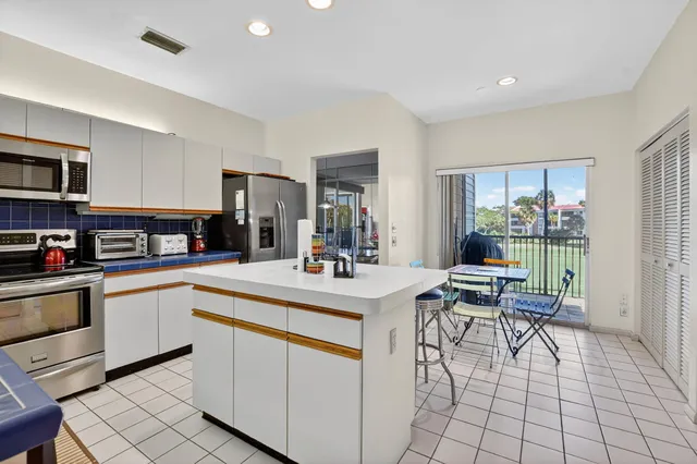 a view of a chairs and table in the balcony