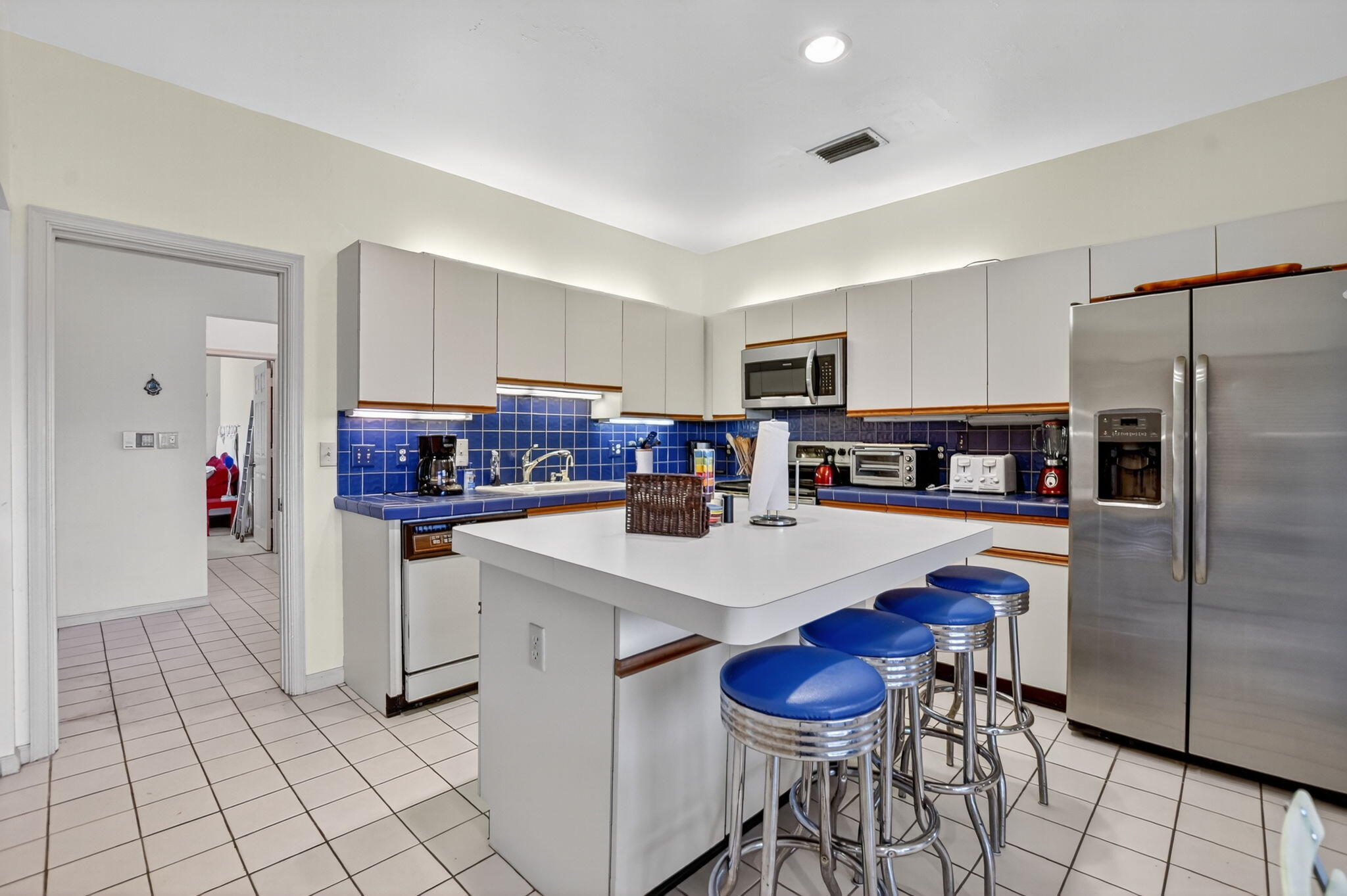 7623 Cinebar Drive, Unit 30U Boca Raton, FL 33433 - Photo 19 of 86 a kitchen with stainless steel appliances a refrigerator and a stove top oven