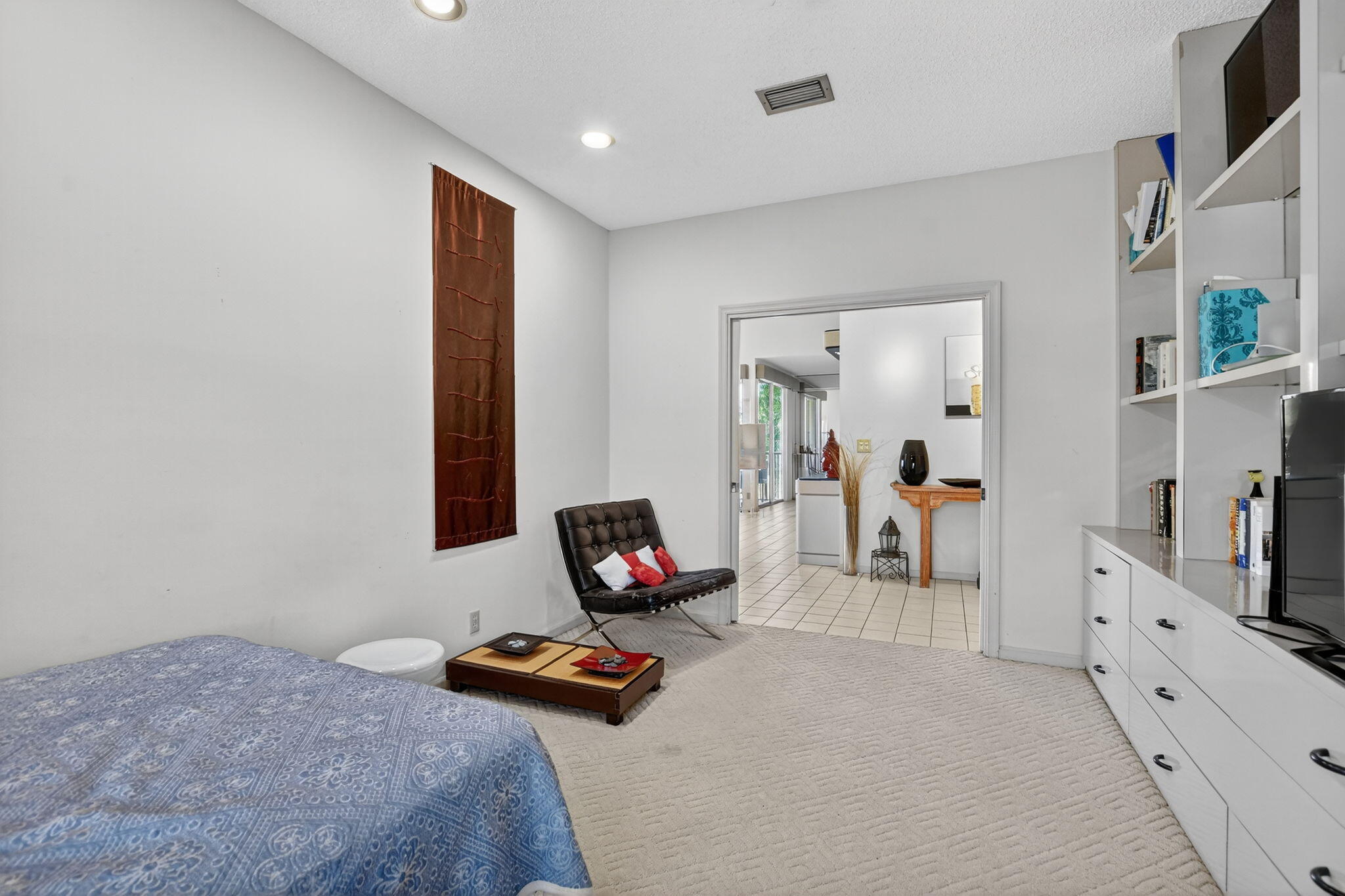 7623 Cinebar Drive, Unit 30U Boca Raton, FL 33433 - Photo 37 of 86 a bedroom with furniture and a flat screen tv